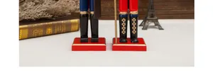 Detailed view of wooden nutcracker soldier boots and stable red square base decoration