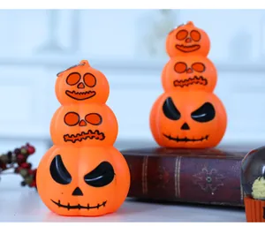 Close-up of three-tiered glowing pumpkin lanterns for Halloween festive decoration