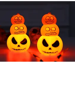 Close-up detail of three-tier stacked glowing Halloween pumpkin lanterns for decorations