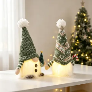 Festive set of two light-up green knitted Christmas gnomes with warm glowing fur bodies