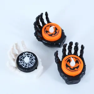 Halloween skeleton hand LED tea light candles with pumpkin and spider web motifs