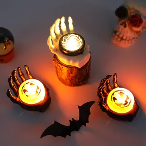 Halloween skeleton hand LED candle lights with spooky pumpkin and spider web patterns