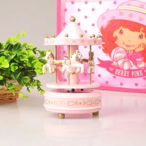 Decorative pink carousel music box with golden accents and white horses for room decor