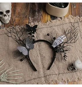 Detailed view of Halloween headband with black branches, skeleton hand and butterfly