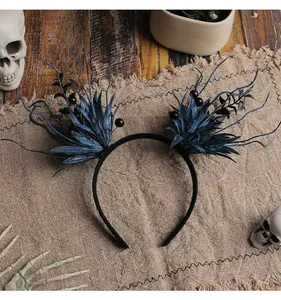 Detail view of dark blue Halloween headband with branch and leaf decorations.