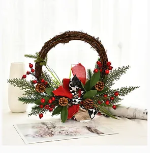 Close-up detail of a handmade Christmas grapevine wreath with red berries and pine cones