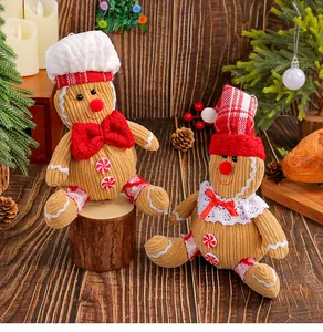 Detail view of corduroy gingerbread man plush dolls in festive Christmas outfits and hats