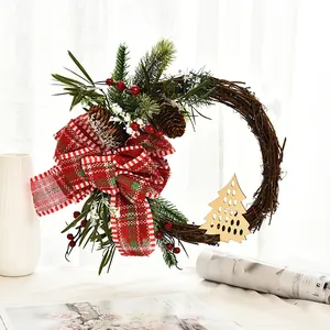 Handmade Christmas wreath with red plaid bow and pine cones for door decoration