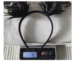 Detailed shot of a black Halloween decorative branch headband weighing 42g on a scale