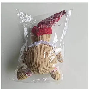 Back view of plush gingerbread man Christmas ornament in clear plastic packaging.