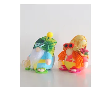 Close-up of two adorable beach-themed plush gnomes with sunglasses and tropical hats
