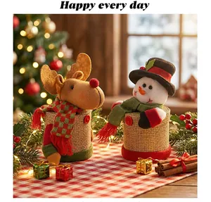 Detailed view of handmade Christmas reindeer and snowman candy jars on a festive table.