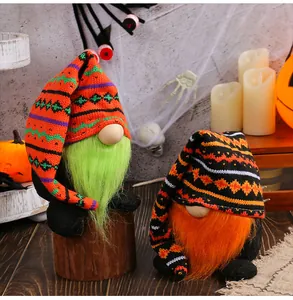Detailed view of two Halloween gnomes with long knitted hats and colorful beards in a festive setting.