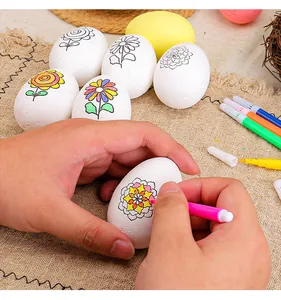 Close-up of coloring an Easter egg with a pink marker in a DIY foam egg set.