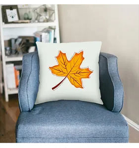 Decorative maple leaf pillowcase for autumn harvest festival on a blue armchair