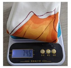 Detailed weight measurement of autumn maple leaf pillowcase showing 74.6 grams
