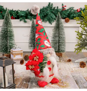 Detailed view of standing Christmas gnome doll with festive red bird print hat and beard.