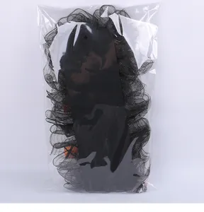 Detail of black Halloween mesh wreath with pumpkin decor in clear packaging