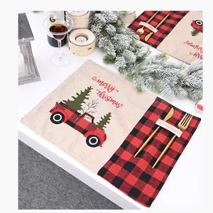 Detailed view of a Christmas placemat featuring a red plaid truck and festive embroidery
