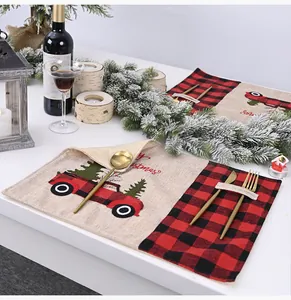 Close-up of festive red and black plaid Christmas placemat with built-in cutlery holder