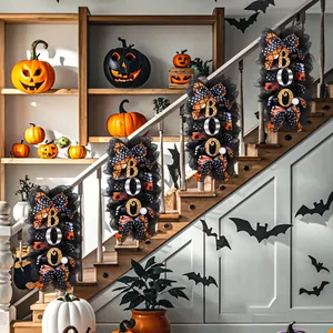 Halloween wreath with BOO signs on black mesh and orange bows for staircase decor.