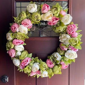 Dettaglio di una ghirlanda di peonie primaverili con fiori rosa e bianchi su porta in legno