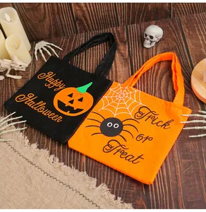 Detailed close-up of Halloween candy gift bags featuring pumpkin and spider designs