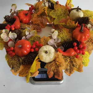 Detailed view of an autumn wreath with pumpkins and berries weighed on a scale