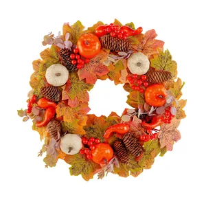 Decorative autumn wreath featuring pumpkins pine cones and red berries for Thanksgiving decor