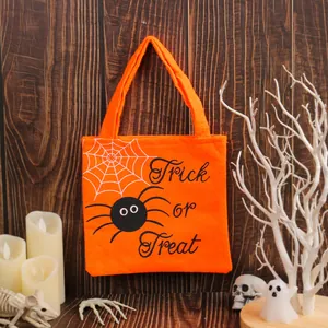 Festive orange Halloween Trick or Treat candy tote bag featuring spider and web design