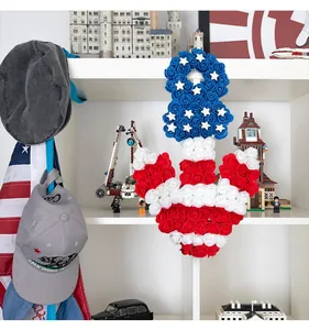 American flag patriotic anchor wreath with red white and blue PE roses on bookshelf.