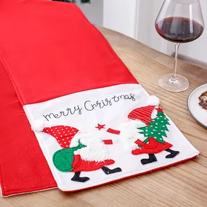 Festive red Christmas table runner with embroidered Santa gnomes for home decor