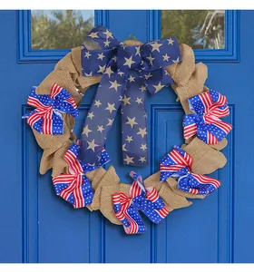 Decorative patriotic Independence Day burlap wreath with American flag bows on a blue door