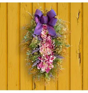 Close-up of artificial purple hydrangea floral swag with a satin bow for door decor