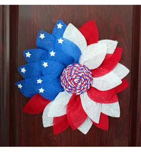 Patriotic American flag wreath decoration displayed on a dark wood door.