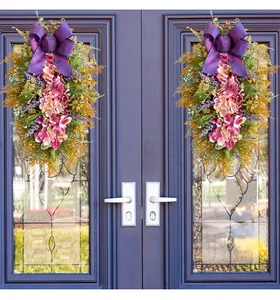 High-quality detailed view of an artificial purple hydrangea door swag with a large purple bow.