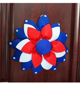 Detail view of Independence Day patriotic flower wreath hanging on dark wooden door