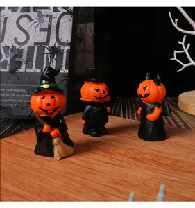 Detailed macro view of three miniature resin Halloween pumpkin figurines in cute costumes