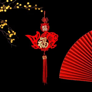 Traditional Chinese New Year fish ornament with golden Fu character and red tassels