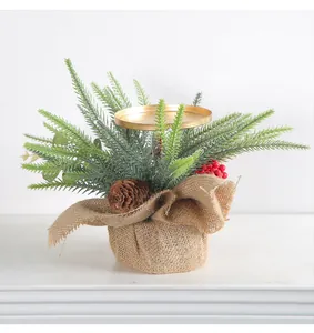 Detailed view of small Christmas candle holder with pinecone, red berries, and burlap base.