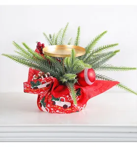 Detailed view of festive Christmas candle holder featuring red berries and pine needle decor