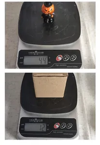 Weight measurement showing 44g Halloween mini pumpkin figurine and box packaging.