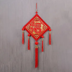 Detail view of red Chinese New Year hanging decoration with Fu character and tassels