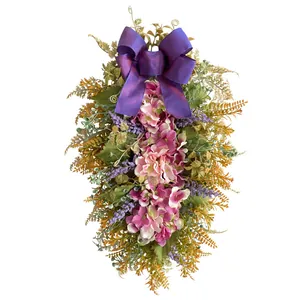 Artificial purple hydrangea floral swag with a large satin bow for door decoration
