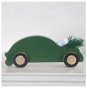 Side view detail of a dark green wooden car ornament carrying a miniature Christmas tree
