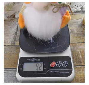 Detail shot showing an Easter gnome plush doll weighing 92 grams on a precision scale