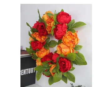 Detailed view of artificial red and yellow peony wreath for wedding wall decoration