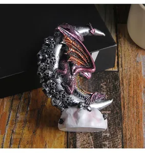 Gothic dragon resin statue detailed view perched on a skull-covered crescent moon base