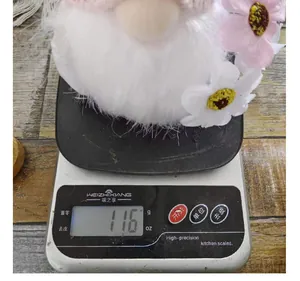 Weight measurement detail of an Easter plush gnome doll on a digital kitchen scale