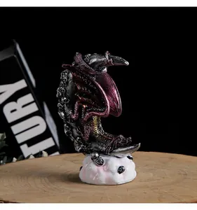 Detailed view of gothic resin dragon statue perched on a skull-textured crescent moon.